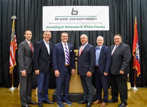 members of bryce corporation standing in front of a podium