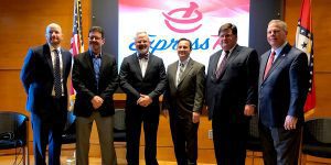 men in suits standing beside each other for a photo